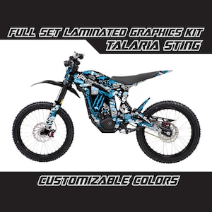 May include: Full set laminated graphics kit for a Talaria Sting electric dirt bike. The graphics feature a black and blue colour scheme with a variety of graphic elements, including a Monster Energy logo, a skull, and the words "Rock Shop".