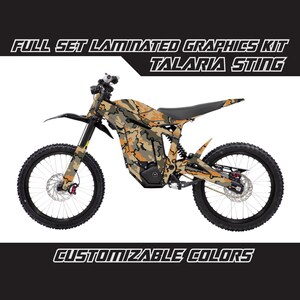 May include: Full set laminated graphics kit for a Talaria Sting electric dirt bike. The kit features a camouflage pattern with brown, tan, and green colours. Customizable colours are available.