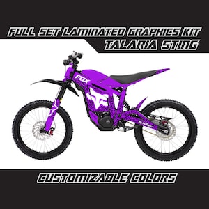 May include: Full set of laminated graphics for a Talaria Sting electric dirt bike. The graphics feature a purple and black leopard print design with the word "FOX" in white lettering. Customizable colors are available.
