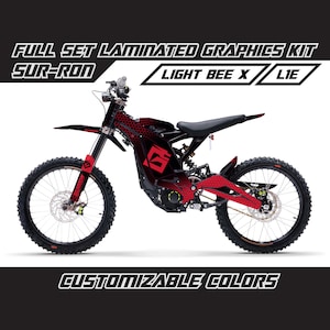 May include: A black and red Sur-Ron Light Bee X electric dirt bike with a honeycomb pattern graphic. The bike has a black seat, black handlebars, and black wheels with red accents. The text "FULL SET LAMINATED GRAPHICS KIT" and "CUSTOMIZABLE COLORS" is printed on the image.