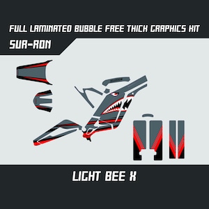 May include: A grey and red graphic kit for a Sur-Ron Light Bee X electric motorcycle. The kit features a shark design with red accents and the Sur-Ron logo.