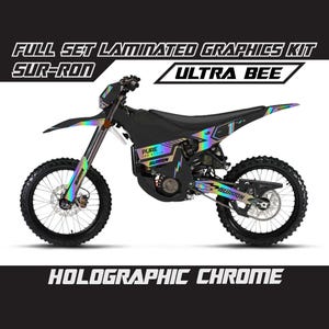 Könnte beinhalten: Ein schwarzes und holographisch verchromtes Sur-Ron Ultra Bee Elektro-Dirtbike. Das Motorrad verfügt über einen kompletten Satz laminierter Grafiken. Der Text "HOLOGRAPHIC CHROME" wird unten im Bild angezeigt.