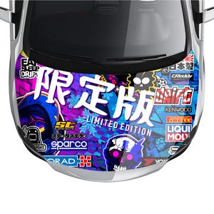 May include: A car hood with a vibrant, multi-colored graphic design. The design features Japanese text, a skull, and various brand logos. The words "LIMITED EDITION" are also visible. The hood is silver with a black windshield.