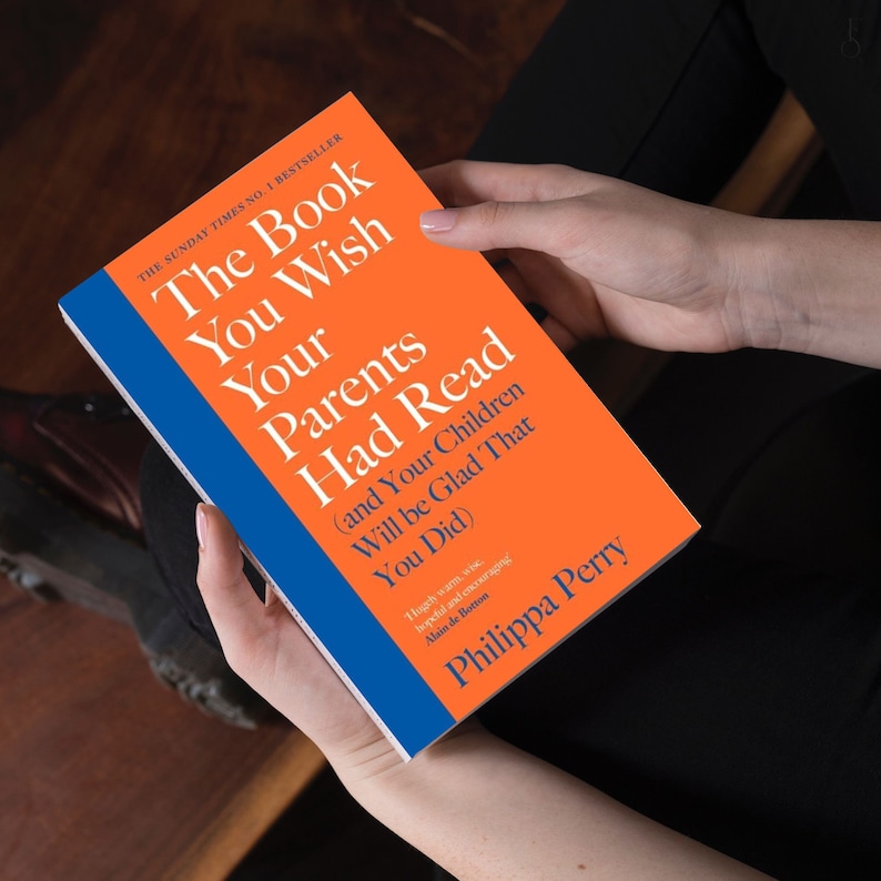 May include: A bright orange book with a blue stripe on the cover. The title is "The Book You Wish Your Parents Had Read (and Your Children Will Be Glad That You Did)". The author is Philippa Perry.