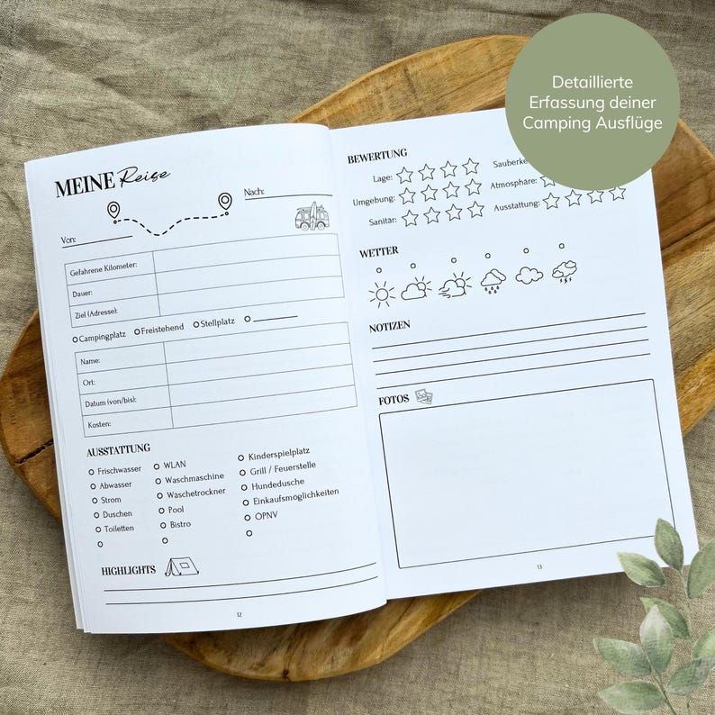 May include: A black and white camping trip log book with a checklist of amenities, a section for notes, and a place to rate the campsite. The book has the title "Meine Reise" on the cover.