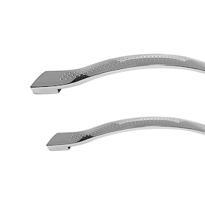 May include: Two silver, curved cabinet door handles with a dotted pattern.