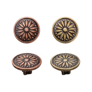 May include: Four decorative metal buttons with a floral design. Two buttons are copper and two are gold.