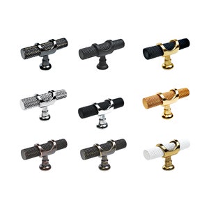 May include: Nine different finishes of a decorative cabinet knob with a textured cylindrical bar and a curved top. The finishes include black, nickel, chrome, bronze, gold, and white.