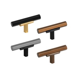 May include: Four cabinet pulls in different finishes: black, copper, bronze, and nickel. Each pull has a rectangular bar with a T-shaped base.