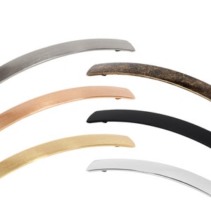 May include: Five different finishes of a curved cabinet handle. The handles are made of metal and have a brushed finish. The finishes are silver, brass, copper, black, and chrome.