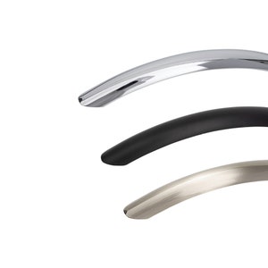May include: Three curved cabinet pulls in different finishes: chrome, black, and brushed nickel.