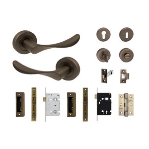 May include: A set of two antique bronze door handles with matching hardware, including a latch, strike plate, and hinges. The handles have a curved design and are suitable for interior doors.
