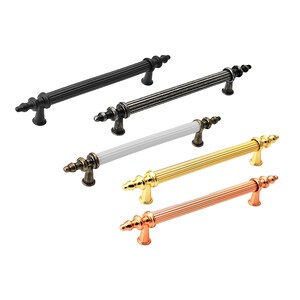 May include: Five different cabinet pulls with a decorative fluted design. The pulls are in black, grey, white, gold, and copper.
