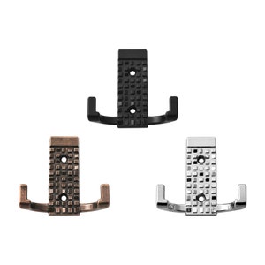 May include: Three double hooks in black, silver, and bronze finishes. Each hook has a square patterned design.