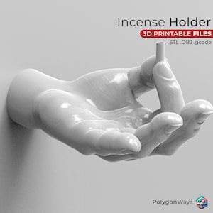 May include: A white ceramic hand sculpture holding a small incense stick. The hand is outstretched with the fingers curled around the stick. The sculpture is designed to be a wall-mounted incense holder. 3D Printable Files .STL .OBJ .gcode
