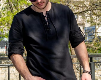 May include: A black long-sleeved shirt with a lace-up neckline and buttoned cuffs.