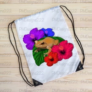 May include: White drawstring bag featuring a brown frog perched on a green leaf with purple, blue, and red hibiscus flowers.