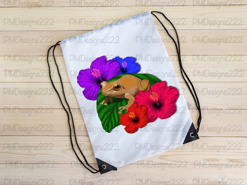May include: White drawstring bag featuring a brown frog perched on a green leaf with purple, blue, and red hibiscus flowers.