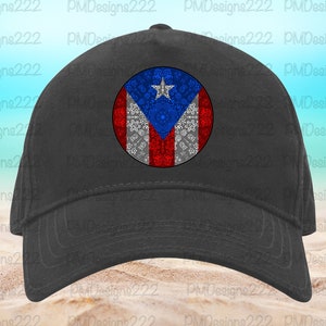 May include: A black baseball cap with a white, red, and blue Puerto Rican flag design in the center. The flag design is surrounded by a white floral pattern.