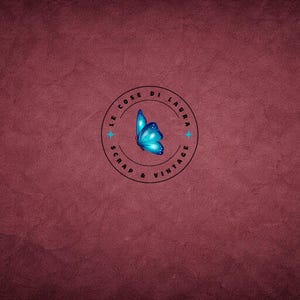 May include: A logo featuring a blue butterfly within a black circular frame. The frame includes the text "LE COSE DI LAURA SCRAP & VINTAGE" in a circular pattern, with two blue star accents. The background is a textured, deep red.