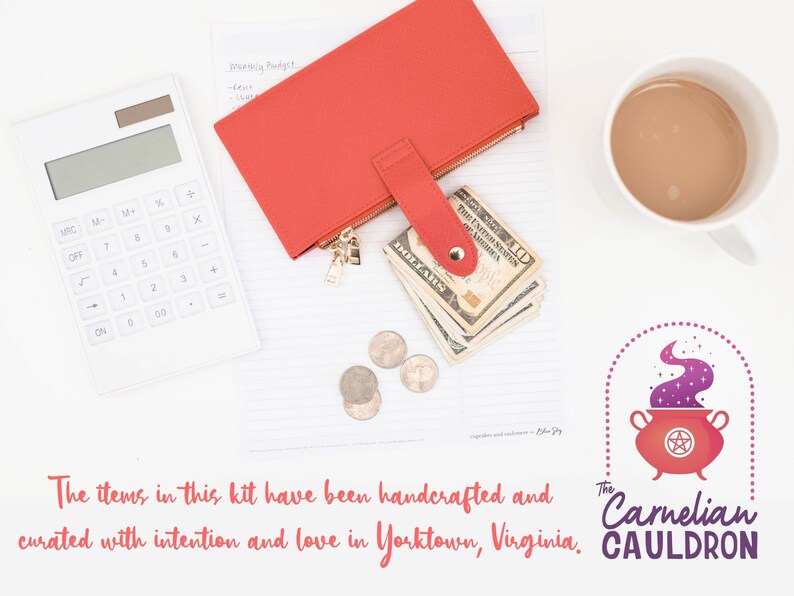 May include: A red leather wallet containing cash and coins, a white calculator, a cup of coffee, and a logo for The Carnelian Cauldon, which features a red cauldron with purple smoke and a pentagram. The text reads "The Carnelian Cauldon".
