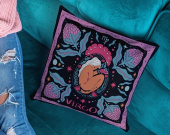May include: A pink and black throw pillow with a floral design and a stylized illustration of a woman with the text "VIRGO" and the astrological symbol for Virgo.