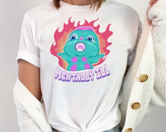 May include: White t-shirt with a cartoon character in flames and the text "Mentally Ill".