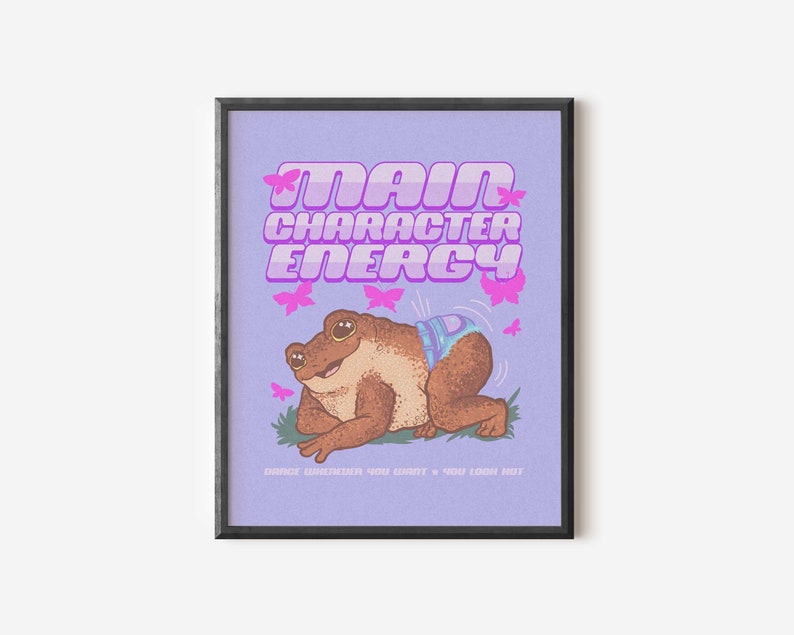May include: A purple poster with the text "Main Character Energy" in pink letters. A cartoon frog wearing a nappy is in the centre of the poster. The frog is surrounded by pink butterflies. The text "Dance whenever you want + you look hot" is at the bottom of the poster.