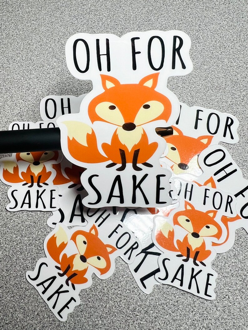 May include: A set of stickers featuring a cartoon fox with the text "Oh for sake". The stickers are white with black text and a cartoon fox with orange fur.