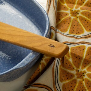 Old Saguaro Cactus logo burned onto the handle of a spatula