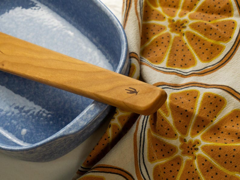 Old Saguaro Cactus logo burned onto the handle of a spatula