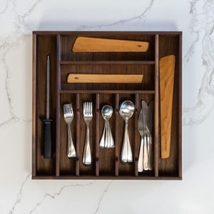 Drawer organizer made from walnut on marvelous marble countertop. Old Saguaro cooking utensils, silverware, and honing steel neatly organized.