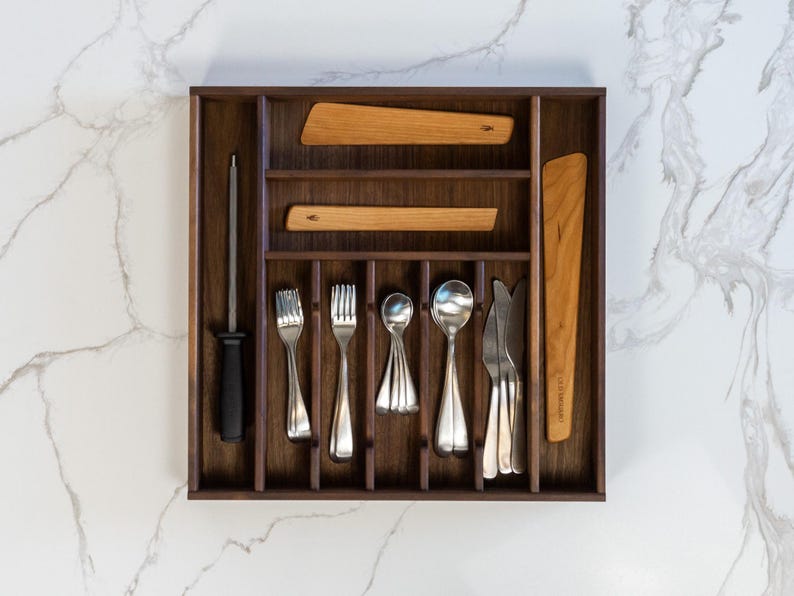 Drawer organizer made from walnut on marvelous marble countertop. Old Saguaro cooking utensils, silverware, and honing steel neatly organized.