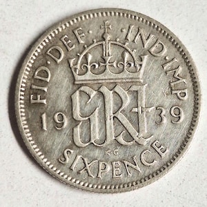 1939 British silver sixpence coin in good condition. The coin you see in the pictures is what you get!