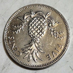 May include: A silver coin with a pineapple design and the words "FIVE CENTS" around the edge.