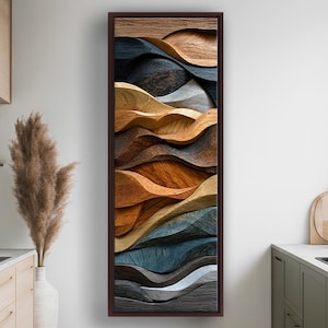 Peut inclure: Une œuvre d'art abstraite encadrée avec un motif de grain de bois. L'œuvre présente des formes ondulantes superposées dans des tons de marron, beige, gris et bleu. L'œuvre est exposée dans une cuisine, ajoutant une touche de décoration moderne.