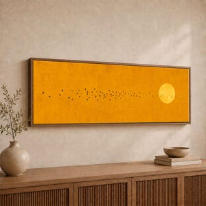 May include: A rectangular wall art piece featuring a vibrant orange background with a textured finish. A large, pale yellow circular sun is positioned on the right side, while a flock of small black birds flies across the centre of the canvas.