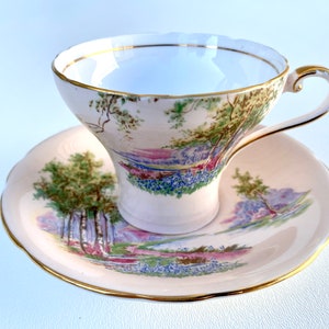 Aynsley Bluebell Tea Cup and Saucer in the "Bluebell Time" Pattern with Pale Pink Ground and Hand Painted Fields of Bluebells