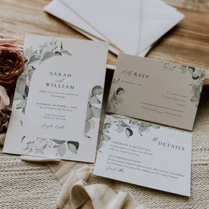 May include: A wedding invitation suite featuring a watercolour floral design. The invitation includes the names Sarah and William, the date Saturday, October 11, 20XX, and the location Central Park Hotel, Manhattan, New York. The RSVP card has a section for guests to confirm their attendance. The details card provides information about the ceremony and reception, which will be held at Villa Exa, Amalfi Coast, Italy.