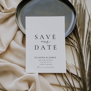 May include: A white save the date card with black text. The text reads "Save our Date" followed by "Elianna & James are tying the knot Sat) Oct 16 | XX London, England Formal invite to follow".