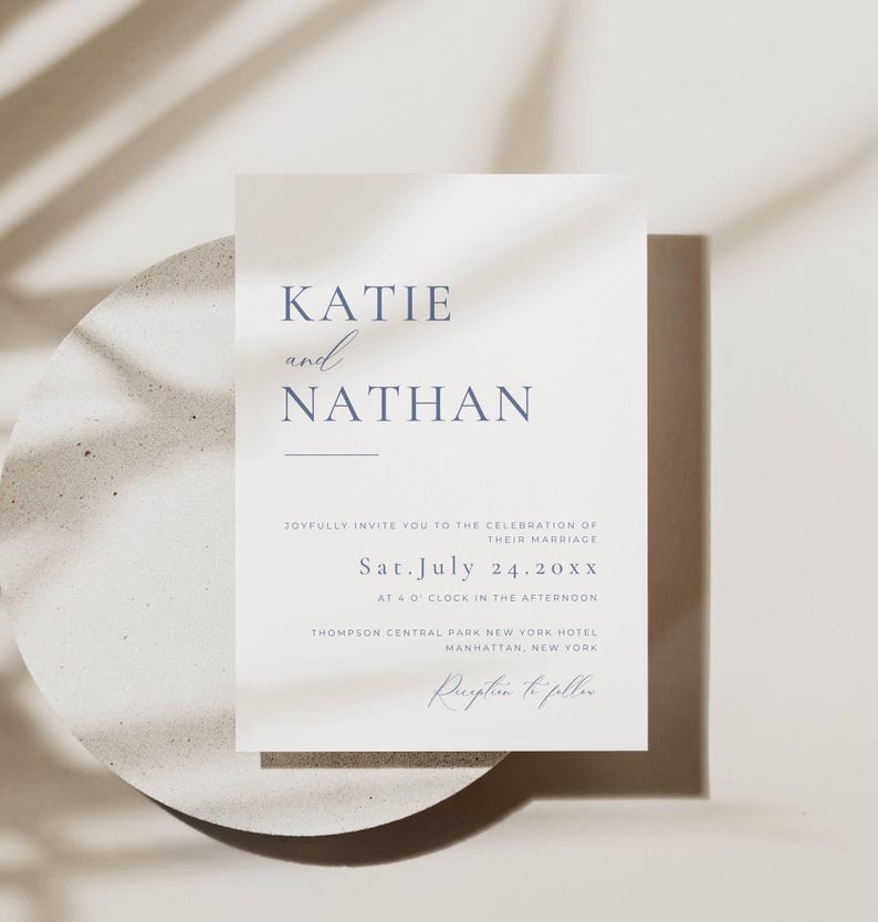 May include: A minimalist wedding invitation with the names Katie and Nathan in a blue font. The invitation details the wedding date as Saturday, July 24, 20XX, at 4:00 PM at the Thompson Central Park New York Hotel in Manhattan, New York. The invitation also states that a reception will follow.