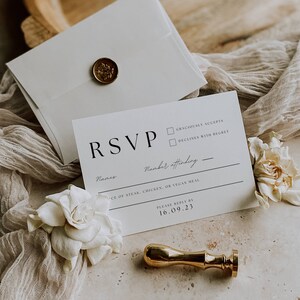 May include: A white RSVP card with a gold wax seal. The card has a black RSVP heading, a line for names, a line for the number of people attending, a line for meal choices, and a line for the RSVP deadline. The deadline is 16.09.23.