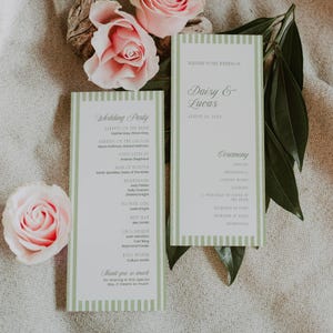 May include: Two wedding programs with green striped borders and text, alongside pink roses and greenery. The programs read "Wedding Party" and "Daisy & Lucas, August 24, 2023", listing ceremony details and participants.