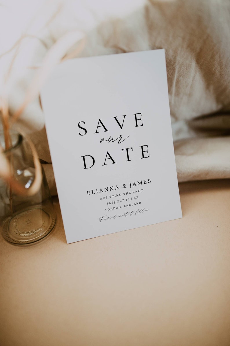 May include: Save the date card with a white background and black text. The card says "Save our date" and includes the names "Elianna & James" and the date "Sat) Oct 16 | XX". The card also includes the location "London, England" and the text "Formal invite to follow".