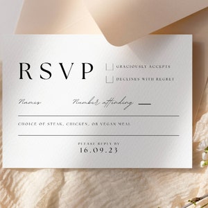 May include: A white RSVP card with black text. It has a section for names, number attending, choice of meal, and a section to indicate if the guest will be attending or declining. The text reads "RSVP", "Names", "Number attending", "Choice of steak, chicken, or vegan meal", "Graciously accepts", "Declines with regret", and "Please reply by 16.09.23".
