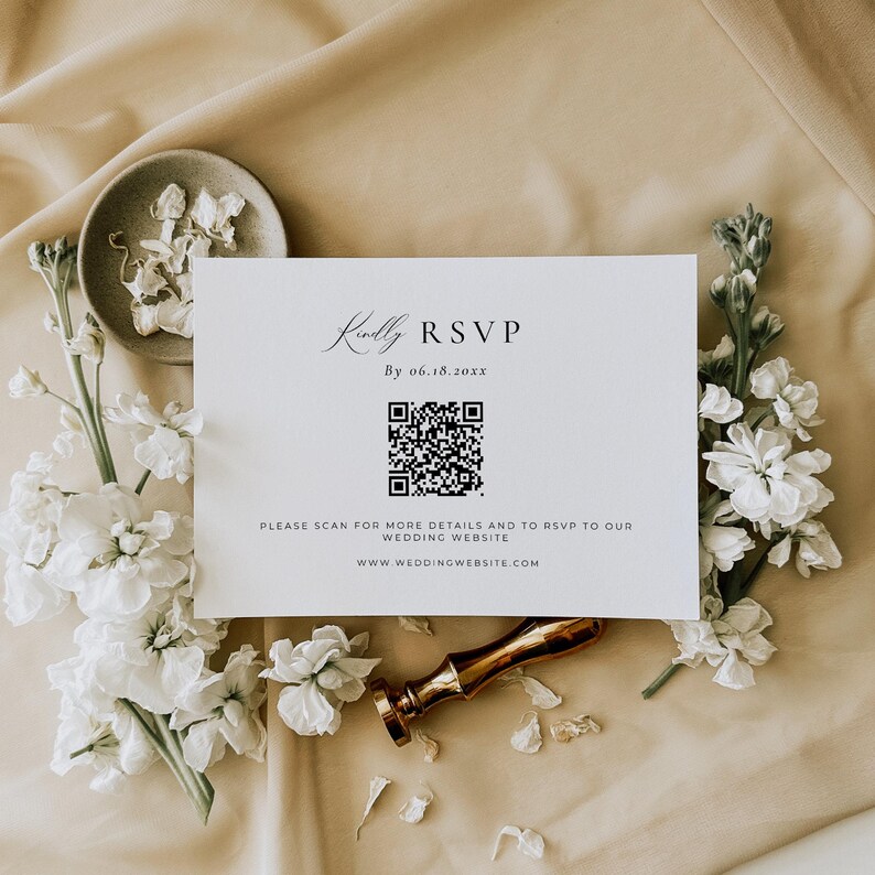 May include: A white RSVP card with a black and white QR code. The text on the card reads "Kindly RSVP By 06.18.20xx" and "Please scan for more details and to RSVP to our wedding website www.weddingwebsite.com".