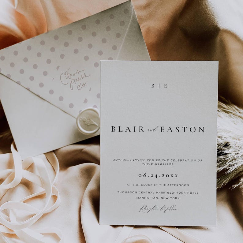 May include: A white wedding invitation with a simple design. The invitation features the names "Blair and Easton" and the date "08.24.20XX". The invitation also includes the location of the wedding, which is the Thompson Central Park New York Hotel in Manhattan, New York.