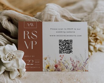 May include: A white card with brown text that says "RSVP" and a QR code. The text below the QR code says "Please scan to RSVP to our wedding website. WWW.WEDDINGWEBSITE.COM". The card has a floral design at the bottom.
