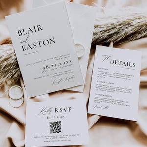 May include: Elegant wedding invitation suite featuring a main invitation, RSVP card, and details card. The invitations are white with black text, including the names "Blair and Easton" and wedding details. Includes a QR code for RSVP.