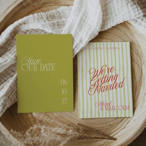 May include: Two wedding announcement cards. One is olive green with the text "Save OUR DATE" and the date "06 10 27". The other card has yellow and white stripes and reads "We're Getting Married" with the names "Hazel & Malcolm".